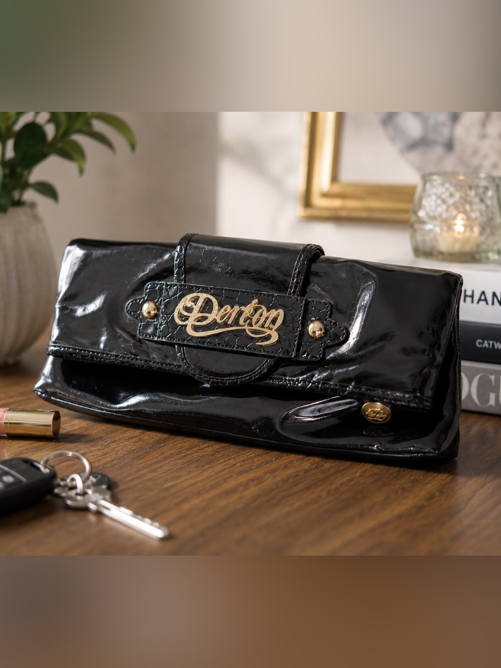 Deréon Black Patent Clutch Bag | Gold Logo & Croc Embossed Trim